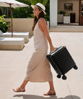 Woman walking with Underseat Carry On Luggage With Spinner Wheels Polycarbonate Hard Shell 17.5 By 12 By 8 Inches Airline Approved