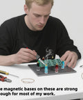 Person using the Magnetic PCB Holder Set For Soldering Six Piece Hands Free Work Station for electronics repair.