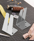 Two Pack Pro Grade Stainless Steel Zipper Jig Tool Set For Quick Zipper Slider Replacement Handy Zipper Pull Install And Repair Zipper Head Size Range From Two Point Five To Ten Durable Craft Tool on a workbench with sewing accessories