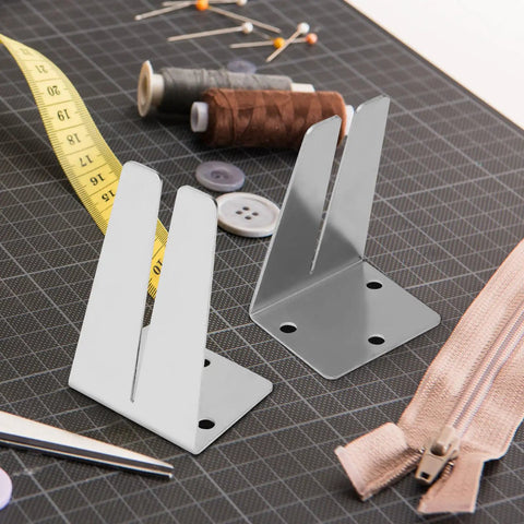 Two Pack Pro Grade Stainless Steel Zipper Jig Tool Set For Quick Zipper Slider Replacement Handy Zipper Pull Install And Repair Zipper Head Size Range From Two Point Five To Ten Durable Craft Tool on a workbench with sewing accessories