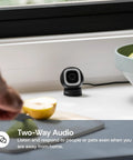 2K QHD Security Camera for Indoor and Outdoor Use For Home Security With 2.4GHz Wired or WiFi, shown on a table near a window.