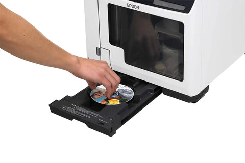 Close-up of hand inserting a printed disc into No Sweat CD DVD BluRay Disc Publisher And Printer With 100 Disc Slot for easy use.