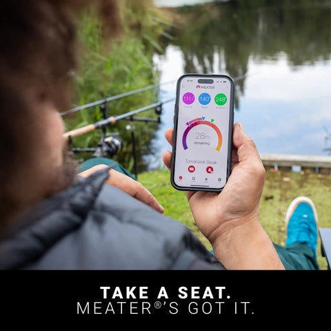 Person using app for 100 Percent Wireless Smart Meat Thermometer With Dual Temp Sensors And Guided Cook System outdoors