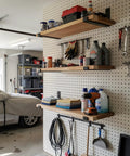 Garage with floating shelves supported by Beefy 8 Inch Shelf Brackets Four Pack For DIY Floating Shelves Heavy Duty Industrial Wall Mount Supports With Black Powder Coat 7.25 Inch By 4 Inch By 1.5 Inch.
