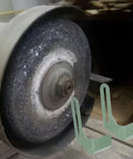 Heavy Duty Iron Grinding Wheel Holder Tool Rest For Bench Grinders Fits 150 Mm And 200 Mm Wheels mounted next to a grinding wheel.