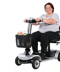Woman on Four Wheel Electric Mobility Scooter For Travel And Everyday Errands With 419 Pound Capacity, front view, basket loaded