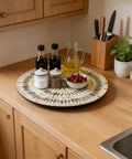 13.4 Inch Round Mother Of Pearl Lazy Susan With Dot Blue Shell Design Hella Smooth Rotating Turntable Tray holding condiments on a wooden kitchen countertop.
