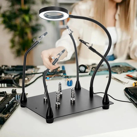 Helping Hands Soldering Clamp Station With 6X LED Magnifying Lamp, four magnetic PCB holders on a table with electronics