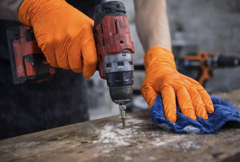 Built Tough 10 Mil Nitrile Gloves With Rock Solid Diamond Grip, Powder Free And Latex Free Orange Safety Gear For Garage Projects, Mechanic Work, And Greasy Cleanup Jobs, Large 100 Count, hands using a drill.