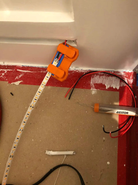 Magnetic Soldering Jig With Nano Suction Base For LED Strip Wiring used in a wiring project, showcasing hands-free operation.