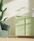 100 Pack 20 Amp GFCI Outlet Low Profile GFI Receptacle With LED Indicators on a green cabinet in a modern living space.