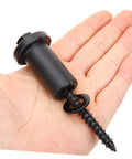 Close-up of a hand holding a 4 Pack Adjustable Barn Door Track Spacer and Wall Connector, heavy-duty black steel, wear resistant.