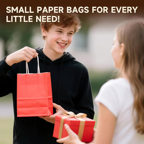 Teen holding red paper bag from Kraft Gift Bags With Handles Bulk Pack 24 Small Party Favor Bags In 6 Colors, 5.8 By 3.2 By 8.25 Inches