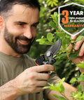 Man using 8.5 Inch Pruning Shears For Easy Cuts With Ultra Sharp Japanese Steel Titanium Blade Arthritis Friendly Garden Clippers