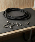 Heavy Duty Flexible Chain Knocker Drain Snake Auger With Solid Steel Core, 16mm shaft and accessories on a workbench.