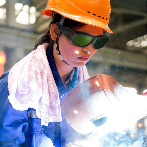 Wrap-Around Welding Glasses Offer Straight-Up UV Shield Blocking 99.9 Percent Rays, Rugged Build, woman welding with protective gear.