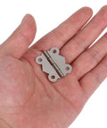 Hand holding a piece from 24 Piece Vintage Butterfly Hinges With Replacement Screws For DIY Furniture Projects Sturdy Iron Hardware