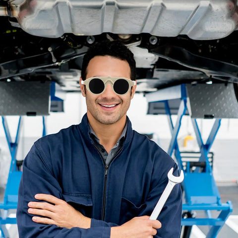 Built Tough Welding Glasses And Protective Goggles For Industrial Grinding, Super Comfy Ergonomic Fit, Straight Up 5 Pack Eye Safety Gear That Takes Zero Hustle To Handle Daily Jobs worn by a smiling mechanic.