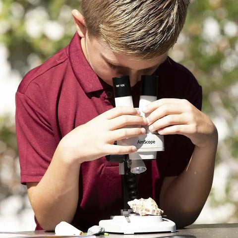 Portable Binocular Stereo Microscope With LED Illumination And 10x Widefield Eyepieces Built For Hands On Learning At Home Or In The Classroom Perfect For Checking Biological Specimens Rocks Stamps Jewelry And Other Tiny Objects, boy using it outdoors