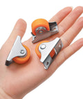24 Pack 1 Inch Rigid Casters With Sturdy Metal Top Plate Low Profile Fixed Wheels For Furniture And Cabinet Parts Smooth Rolling Mount Kit Included In Bold Orange Finish shown on hand.