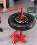 Manual Tire Changer And Bead Breaker Set For 8 To 16 Inch Tires shown in use in a garage with a mounted tire and tools nearby.