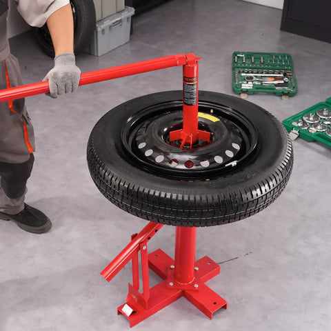 Manual Tire Changer And Bead Breaker Set For 8 To 16 Inch Tires shown in use in a garage with a mounted tire and tools nearby.