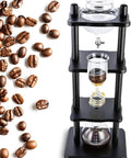 Chill Out Daily With This Sleek Cold Brew Drip Tower Ice Coffee Maker Featuring Smooth Slow Drip Tech And A Killer Thirty Five Ounce Batch Capacity Perfect For Lazy Weekend Sippers In Heat Resistant Borosilicate Glass And Rustic Oak Wood Frame, with coffee beans alongside.