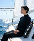 Person sitting on a boat holding a 1L Scuba Tank Kit For Diving Aluminum Cylinder With Primary Valve, near the ocean.