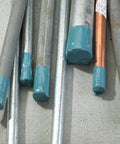 Metal pipes wrapped in Heavy Duty Duct Tape Outdoor Grade Slate Blue 48 Mm By 55 M Roll Pack, used for protection on construction site.