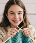 Woman holding large wooden bamboo yarn needles for knitting, showcasing Three Different Sized Nalbinding Needle Set For Knitting And Crochet.