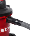 Pro Grade Wet Dry Vacuum Hose Attachment Kit 1.875 Inch Diameter Locking Hose connected to red shop vacuum