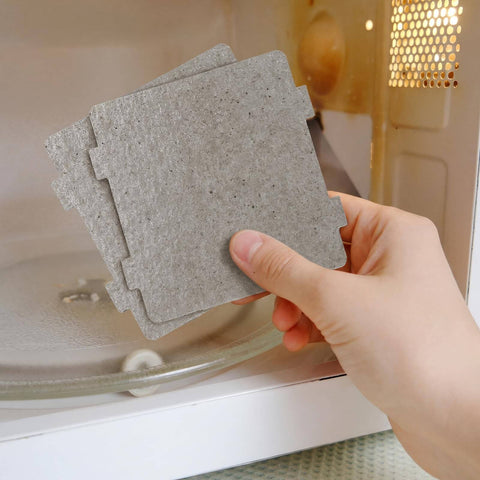 Hand holding 10 Pcs Microwave Mica Sheets Set, Super Thick Heat Shield Waveguide Covers, installing in microwave for kitchen use