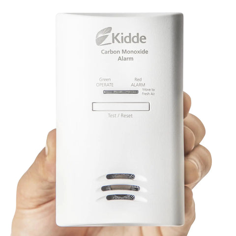 Hand holding Plug In Carbon Monoxide Detector With Battery Backup, 85 DB Alarm, LED Status Lights, Peak Memory, Easy Setup