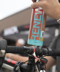 Waterless Ceramic Bike Cleaner Spray With Pina Colada Scent, 16 Oz, Quick Post Ride Shine, Safe On All Finishes, No Water Needed, Easy Touchup For Road, Mountain, And Gravel Bikes, held over bike handlebars