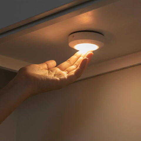 Hand under Color Changing LED Puck Lights Battery Operated With IR Remote 40 Lumens Under Cabinet Lighting And Closet Lighting Wireless