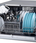 Compact Countertop Dishwasher Featuring Stainless Tub And Seven Quick Wash Options Handles Six Place Settings No Stress In Tight Spaces Energy Star Certified Silver Machine with dishes and utensils.