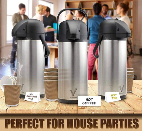 85 Oz Insulated Airpot Coffee Carafe with Pump, Stainless Steel Beverage Dispenser at a party setting with cups labeled for hot beverages