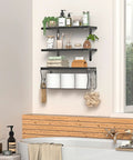 Heavy Duty Floating Bathroom Shelves Wall Mounted Set Of Three With Slick Black Finish For Over Toilet Storage And Moisture Resistant Solid Wood Shelving That Handles Daily Use Without The Drama featuring toiletries and towels.