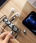 Magnetic Cable Holder Six Slot Cable Clips For Under Desk Self Adhesive Wire Organizer Black with cables and phone on desk
