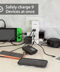 Swivel Power Charging Station With Surge Protection on counter, charging multiple devices via six 3-prong outlets and USB ports.