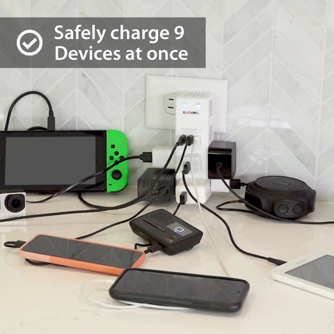 Swivel Power Charging Station With Surge Protection on counter, charging multiple devices via six 3-prong outlets and USB ports.