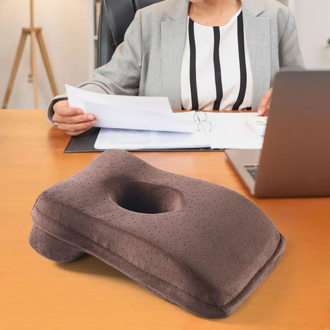 Office Napping Pillow For Neck Support, Ultra Lightweight And Comfy, Travel Friendly Desk Pillow For Naps And Air Travel, Cozy Brown Portable Pillow For Plane, Office Or Train on a desk in office.