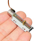 Heavenly Smooth 8MM DC 5V 12V Precision Stepper Motor With 30Mm Stroke Linear Actuator in hand showing metal and screw details.