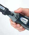 Dremel 575 right-angle rotary tool attachment held in hand; gray/black body with blue label.
