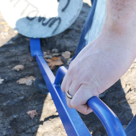 Close-up of hand gripping blue Handled Monster Pry Bar For Demolition And Concrete Removal, 56 Inch All Steel Crowbar With Powder Coat Finish
