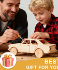 Side view of basswood toy car being assembled by an adult and child with a hobby knife.
