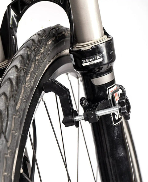 Ultra Portable Bike Wheel Truing Stand For On The Go Rim Adjustment, MTB And Road Bike Wheel Repair Tools attached to fork.