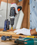 Person using a drill with a yellow dovetail bit on wood, showcasing the Top Tier Four Piece Dovetail Router Bit Set Featuring Precision Bearing Guides For Cabinetry And Fine Woodworking Delivers Straight Up Precision When Run Through CNC Machines Or Standard Routers.