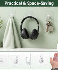 Clear Adhesive Hooks Zero Drama Strong Grip for Shower Wall Organizers No Damage Pegs Bathroom Storage 12 Pieces with headphones and towel.