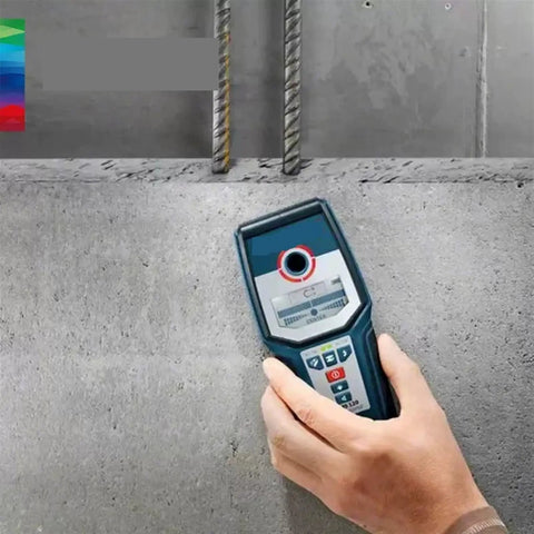 Heavy Duty Stud Finder Wall Scanner With Snappy Metal And AC Wire Detection Drywall Pipe Locator Digital Scanner held against concrete wall.